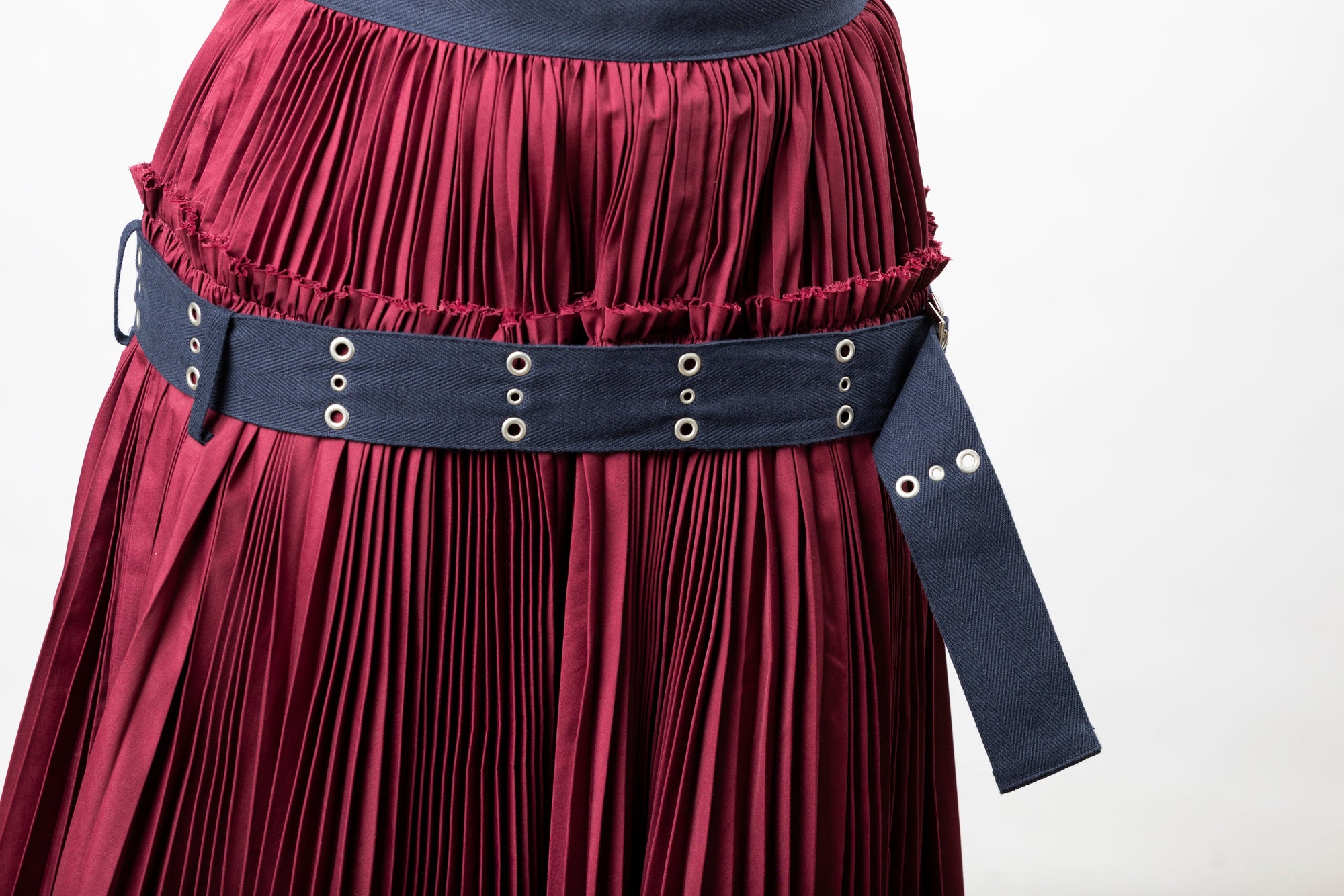 Detail of sacai belted pleated skirt