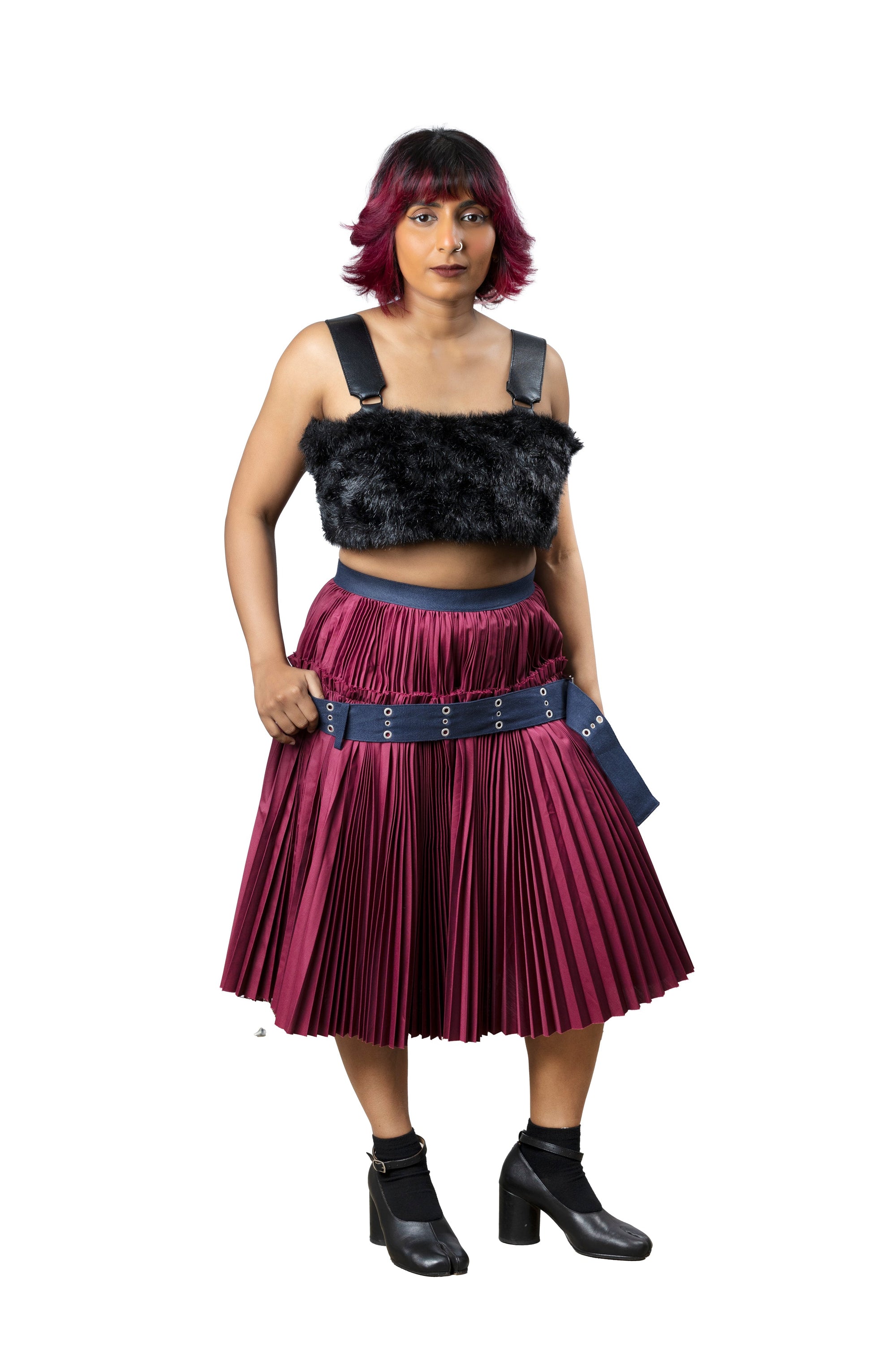Full body picture of model wearing belted pleated sacai skirt
