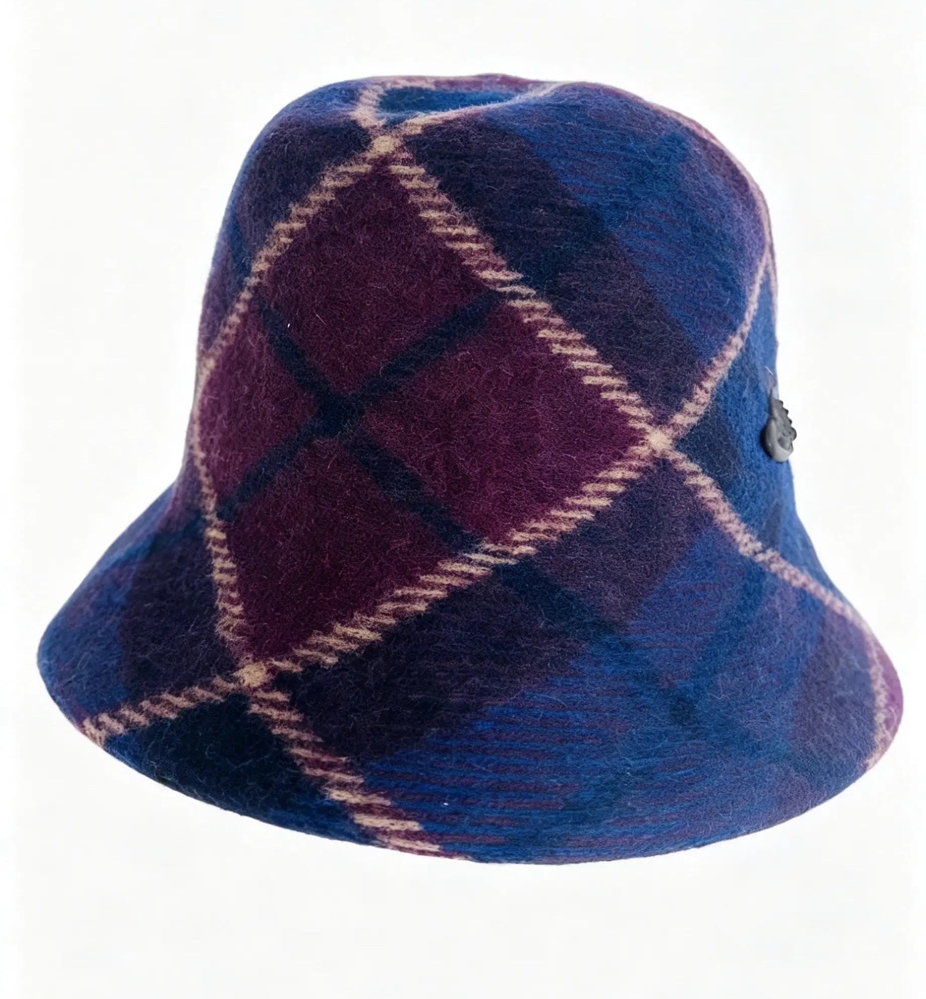 A wool bucket hat featuring a tartan plaid pattern in deep blue and purple with cream-colored diagonal stripes, shown against a plain white background.