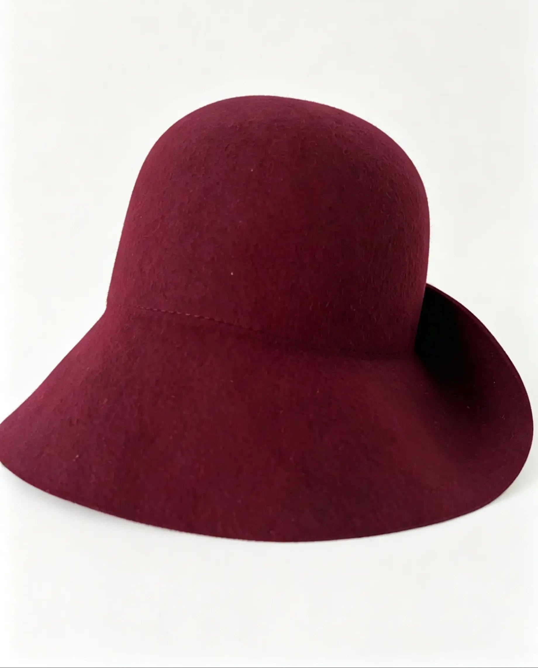 A burgundy felt wide-brim hat photographed on a clean white background.