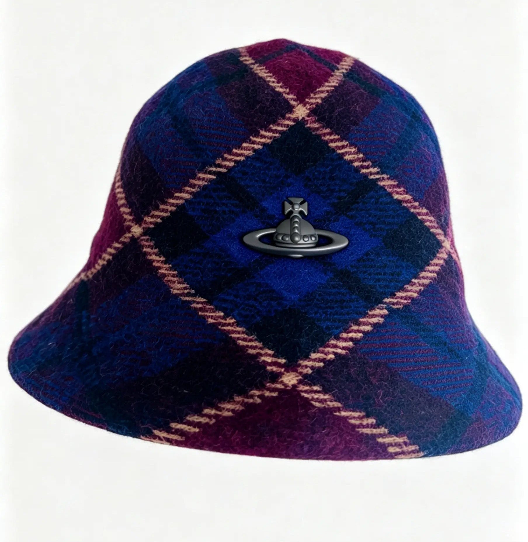 A plaid wool pith helmet in dark blue and purple with pink diagonal stripes, featuring the signature black metal Venus ring logo on the front, set against a plain white background.